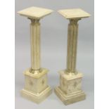 A PAIR OF BEIGE MARBLE AND ORMOLU COLUMNS. 3ft 3ins high.