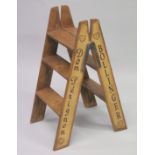 A PAIR OF NOVELTY PINE CHAMPAGNE STEPS. 34ins high.