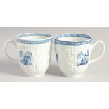 TWO LIVERPOOL CRISPLY MOULDED COFFEE CUPS with blue moulded panels painted with landscapes in blue.