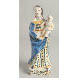 AN 18TH CENTURY FAIENCE POTTERY FIGURE, Madonna and child. 12ins high.