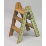 A PAIR OF NOVELTY PINE CHAMPAGNE STEPS. 34ins high.