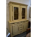 A large cream painted dresser with glazed upper section.