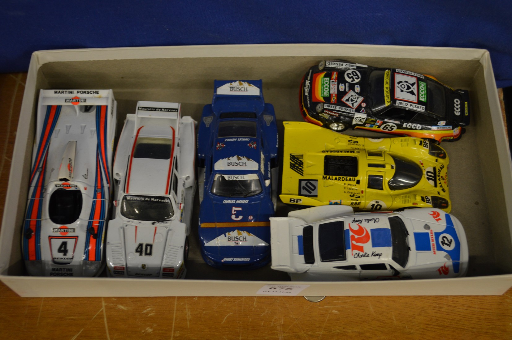 Six model Porsche racing cars.