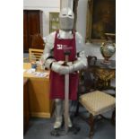 A reproduction suit of armour complete with sword.