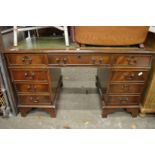 A reproduction pedestal desk.