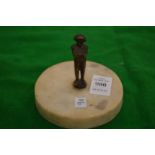 A miniature bronze figure of Napoleon on a marble base.