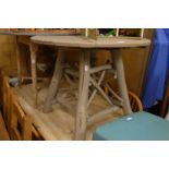 A rustic painted oak circular table.