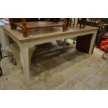 A large part painted extending oak dining table with two leaves.