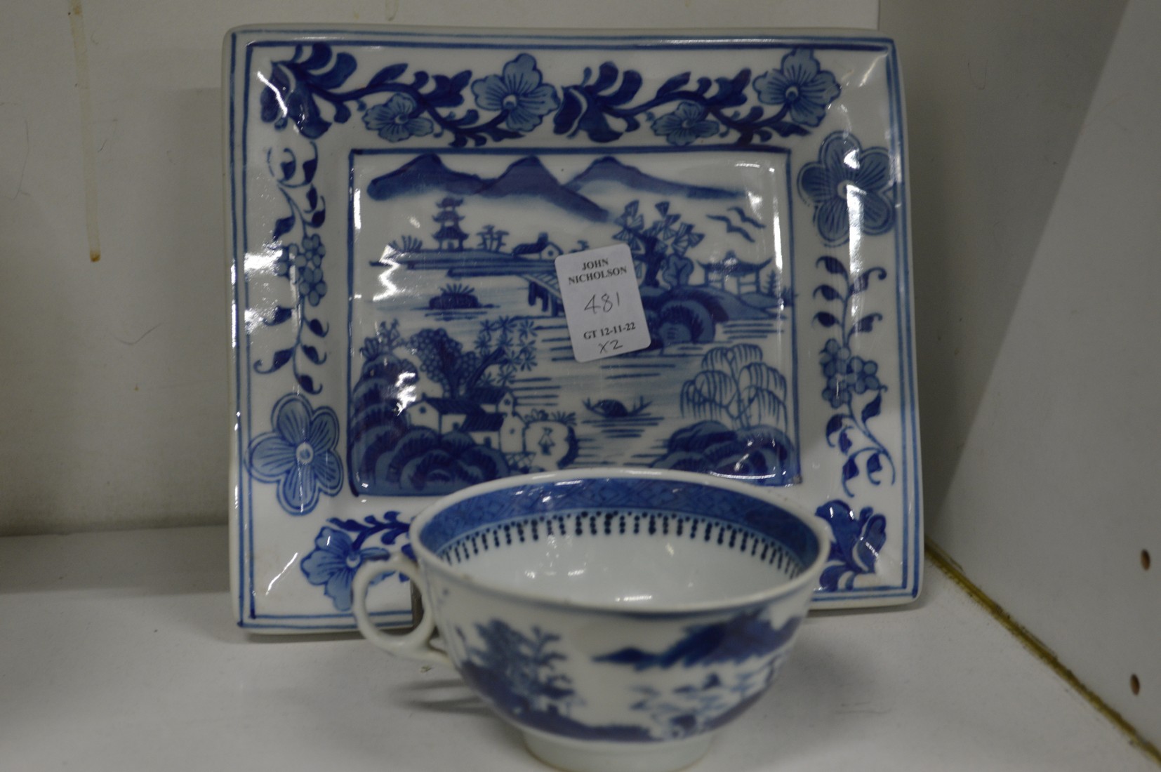 Chinese blue and white cup and a rectangular blue and white dish.