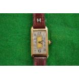 A ladies 9ct gold art deco wrist watch with leather strap.