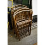 A set of four bamboo folding chairs.