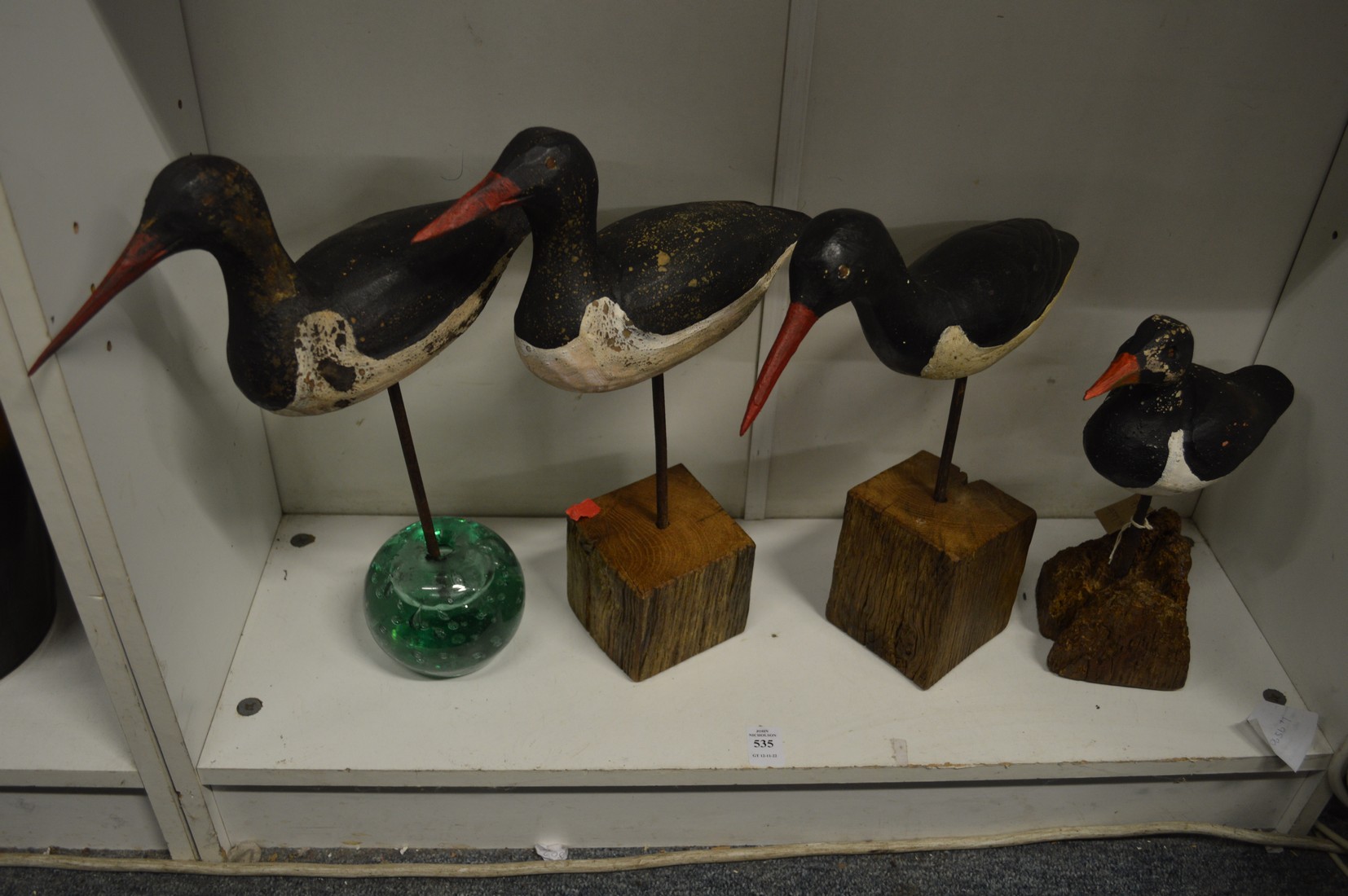 Four carved wood models of sea birds.