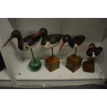 Four carved wood models of sea birds.