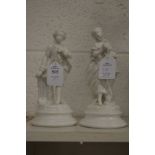 A pair of blanc de chine figures of a young man and lady.