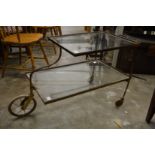A brass and glass two tier trolley.