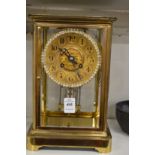 A good brass cased four glass mantel clock with mercury pendulum.