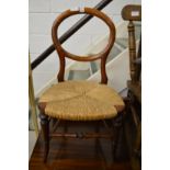 A Victorian mahogany and rush seated balloon back children's chair.