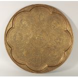 A LARGE ISLAMIC ENGRAVED BRASS TRAY, finely engraved with panels of figures on a foliate background,