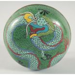 A CHINESE GREEN GROUND CLOISONNE CIRCULAR BOX, decorated with a dragon, 11cm diameter.