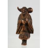 A JAPANESE CARVED WOODEN NETSUKE of a traveller carrying a gourd shape bottle over his shoulder, 5.