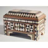 AN ISLAMIC MOTHER OF PEARL AND TORTOISESHELL INLAID WOODEN BOX, the hinged lid with calligraphic