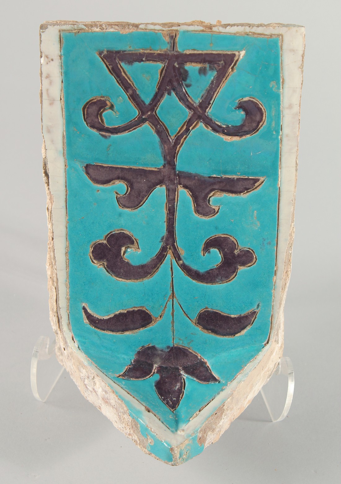 A RARE 14TH CENTURY PERSIAN OR CENTRAL ASIAN TIMURID GLAZED POTTERY MUKARNAS TILE, with turquoise