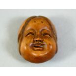 A SMALL CARVED WOOD NETSUKE, okame mask, 2.5cm.