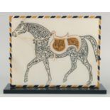 A LARGE ISLAMIC CALLIGRAPHIC MARBLE PLAQUE, the calligraphic image in the form of a horse with