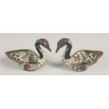 AN UNUSUAL PAIR OF CLOISONNE ENAMELLED METAL SWAN SALTS, 6.5cm wide.