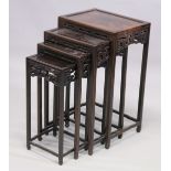 A GOOD LATE 19TH CENTURY NEST OF FOUR CHINESE ROSEWOOD RECTANGULAR TABLES, each with a pierced and