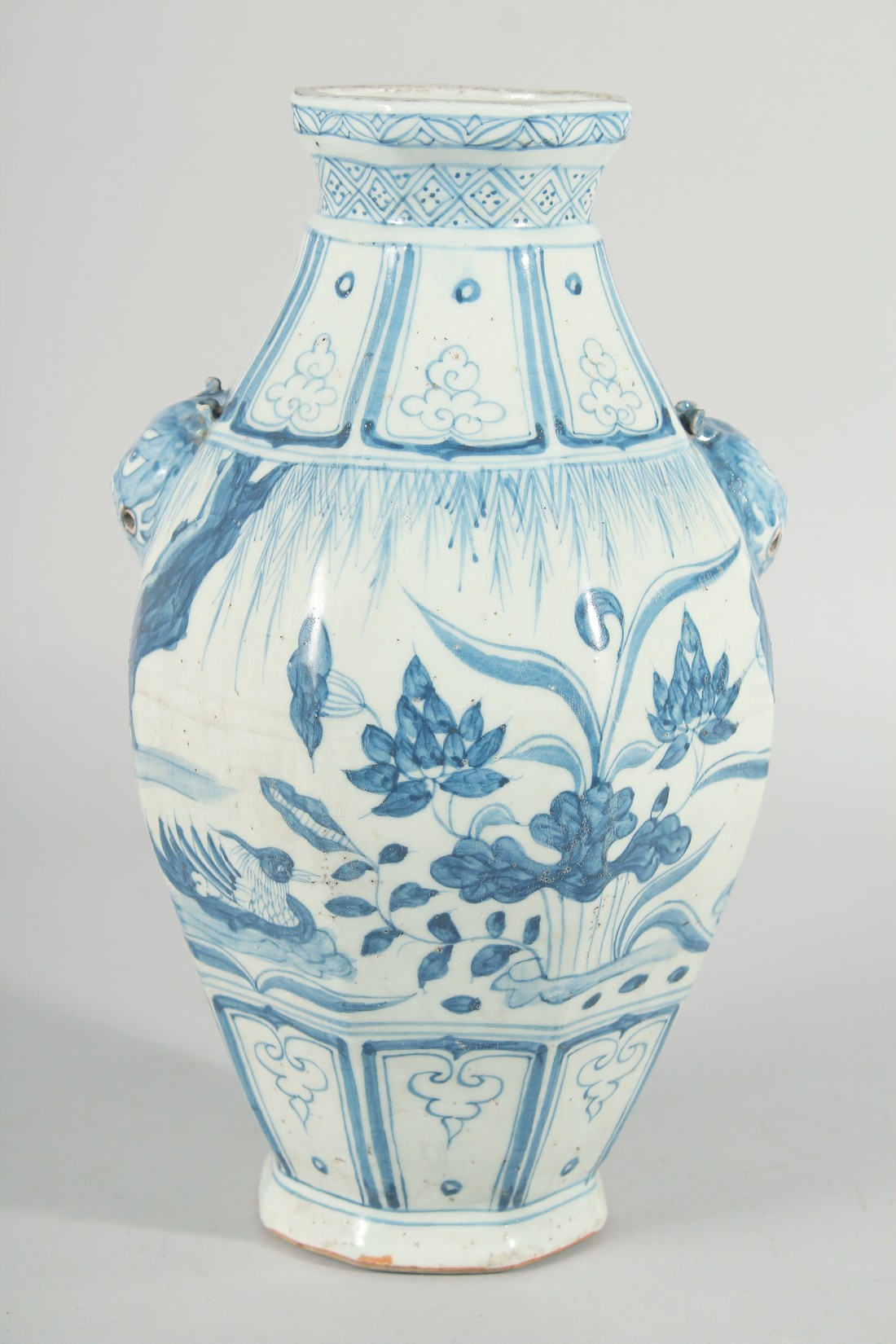 A CHINESE OCTAGONAL BLUE AND WHITE TWIN HANDLE VASE, with moulded lion heads as handles, the body - Image 3 of 6