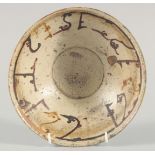 AN EARLY ISLAMIC PERSIAN KUFIC POTTERY BOWL, 21cm diameter.