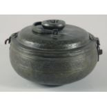 A 16TH/17TH CENTURY OTTOMAN TURKISH TINNED COPPER LIDDED BOWL, with swing handle and hooked latch,