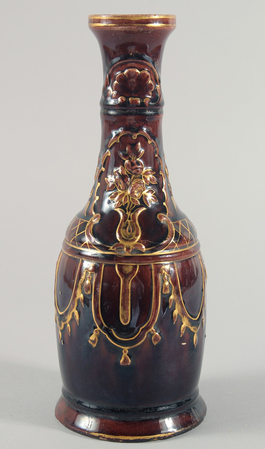 AN UNUSUAL GLAZED POTTERY HUQQA BASE, with gilt painted decoration, 29cm high.