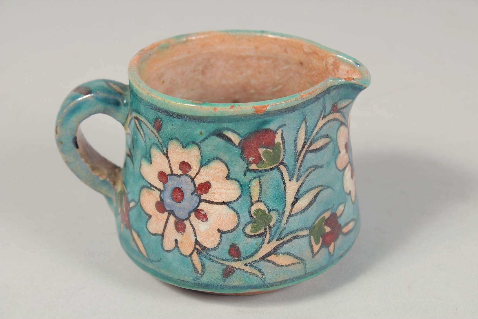 A PALESTINIAN TURQUOISE GLAZE POTTERY PART TEA SET, each piece painted with floral decoration, - Image 6 of 10