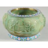 A CHINESE CARVED GREEN HARDSTONE BOWL with cloisonne banded rims, the exterior carved with immortals