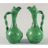 A PAIR OF 19TH CENTURY OTTOMAN TURKISH CANAKKALE GREEN GLAZED POTTERY EWERS, each approx. 34cm