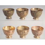 A VERY FINE SET OF SIX 18TH/19TH CENTURY OTTOMAN TURKISH GILDED COPPER TOMBAK OPENWORK ZARF CUPS,