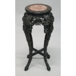 A 19TH CENTURY CHINESE HARDWOOD CIRCULAR STAND with marble inset top, pierced and carved frieze on