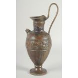 AN EARLY CLASSICAL BRONZE EWER, with a band of archaic style figures to the body, 35cm high.