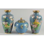 TWO CHINESE BLUE GROUND CLOISONNE VASES, and a similar jar with associated cover, vases 23.5cm high,