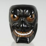 A JAPANESE CARVED LACQUERED WOODEN NOH MASK, signed in gilt to the reverse. 4cm x 3.5cm