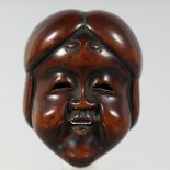 A JAPANESE CARVED WOODEN NOH MASK, signed to the reverse, 5cm x 4cm