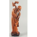 A LARGE CARVED WOOD FIGURE OF AN IMMORTAL, mounted to a carved and pierced hardwood base, 46.5cm