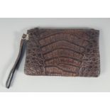 A 1940's - 1950's BROWN CROCODILE SKIN HANDBAG with raised skin, fitted interior with a purse. 8.