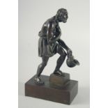 A GOOD GRAND TOUR BRONZE FIGURE OF A MAN holding a helmet. 8.5ins high.