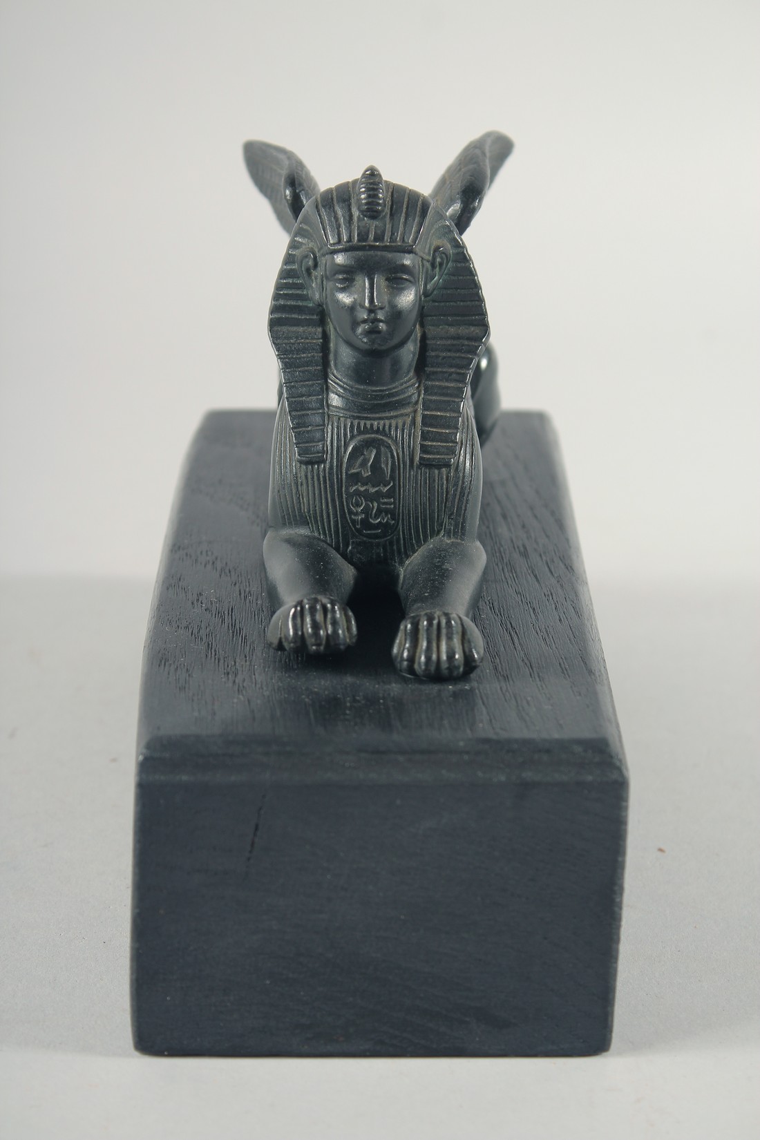 AN EGYPTIAN BRONZE SPHYNX, 6ins long on a wooden base. - Image 2 of 4