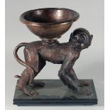 A BRONZE OF A MONKEY a bowl on its back. 15ins high.