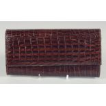 A 1940's - 1950's BLACK PATENT CROCODILE SKIN PURSE. 7.5ins long, 4ins deep.