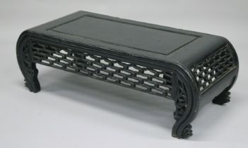 A CHINESE EBONISED LOW TABLE with curving end supports. 3ft 3.5ins x 1ft 4.5ins.
